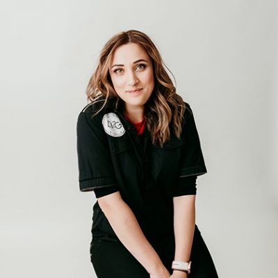 picture of yana siting in front of white wall